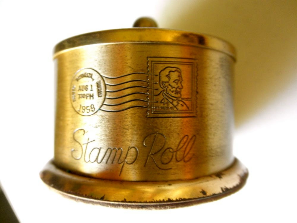 1959 Brass Postage Stamp Roll Dispenser with Abe Lincoln Image