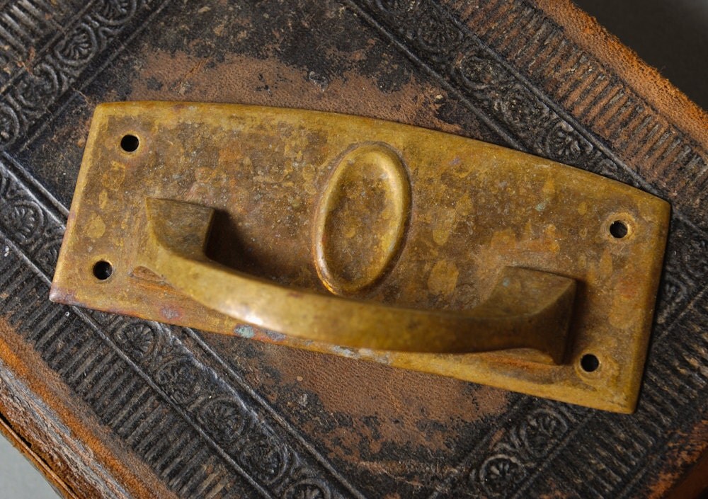 Antique escutcheon with drawer pull handles.