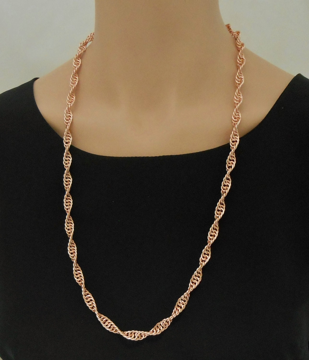 Chain maille spiral necklace in rose gold colored enameled
