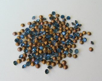 100 Swarovski Montana blue crystal rhinestone chatons with gold foil. 14pp 6ss 2mm