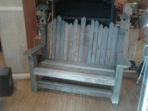 garden bench made from barn board with birdhouses on corners