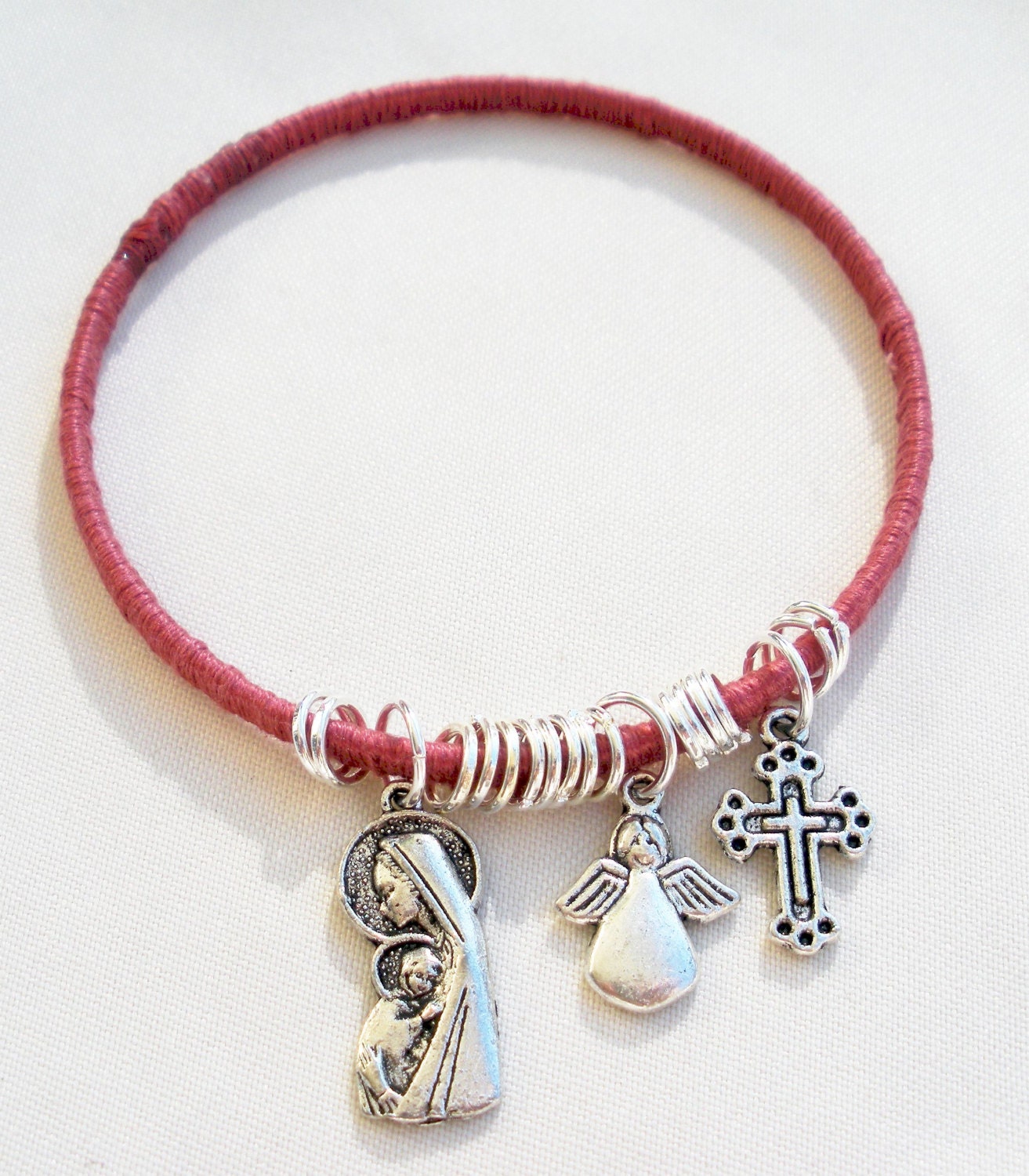 Wrapped pink thread Bangle with mary angel and by TopsailWinds