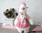 Tiger in a pink dress with heart. Gift for darling. Warm toy as a gift on the date of Valentine. Art animal doll.