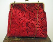 A beautiful kisslock handbag in an embossed iridescent velvet celtic design