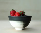 Hand made ceramic bowl in black and white with glossy glaze. Urban and modern look.