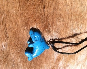 Carved stone dolphin necklace. Made of turquoise.
