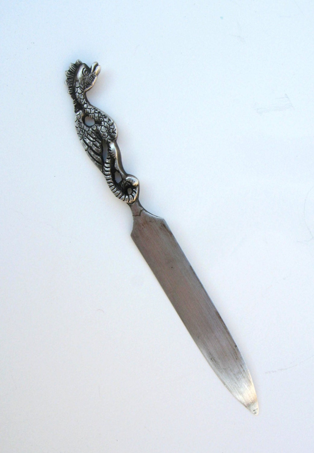 antique silver letter opener with a griffin shaped handle
