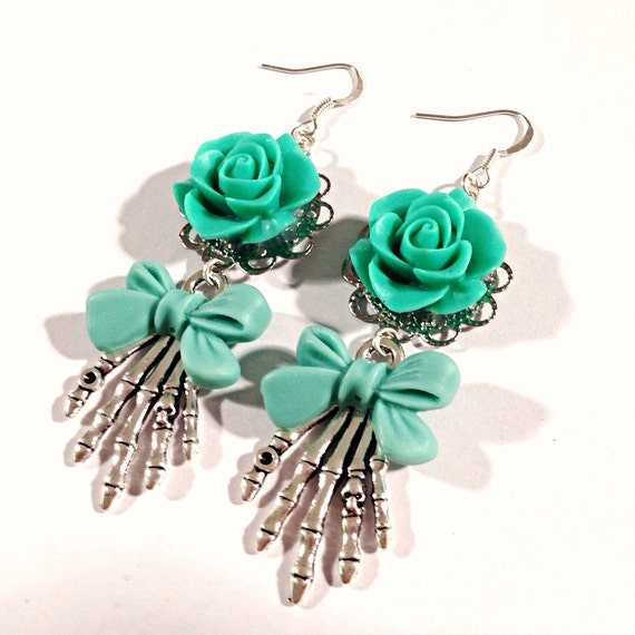 Items similar to Teal Rose Skeleton Hand Bow Earrings on Etsy
