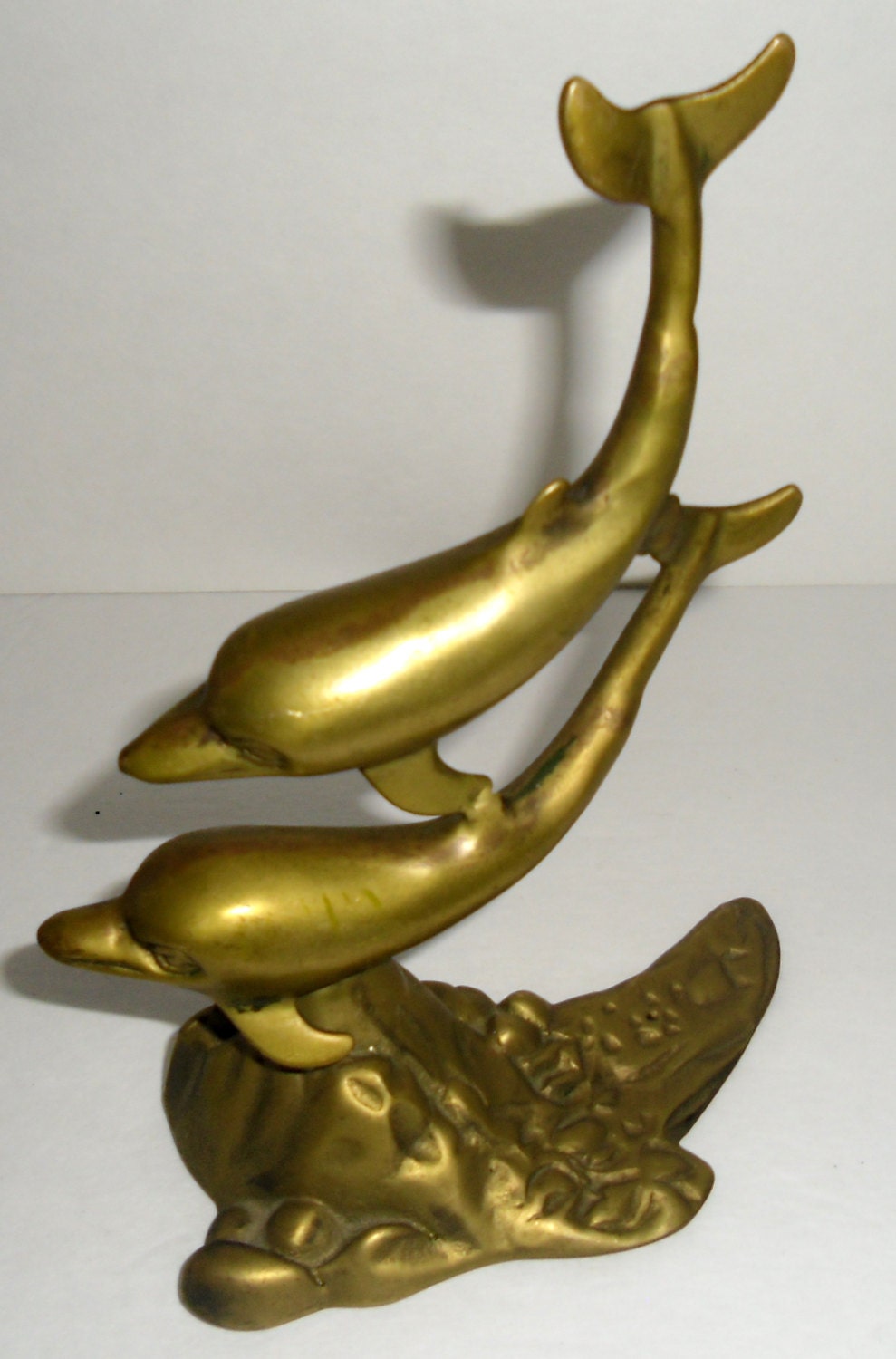 large brass dolphin statue