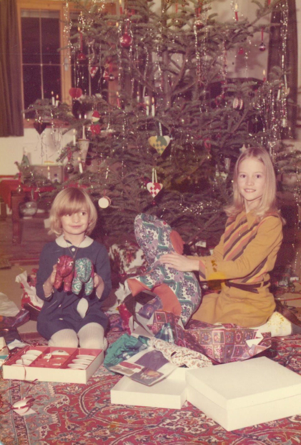 1970s Christmas Morning Girls Sitting Under Tree Opening