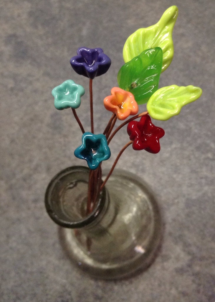 Handmade glass flowers and leaves on copper by ThornburgBeadStudio