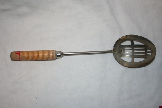 Items similar to Vintage Slotted Metal Spoon with Wood Handle on Etsy
