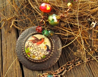 CHOOSE JOY Bronze Resin Filled Bezel Message Necklace and Colorful Green, Red, Faceted Czech Glass Wire Wrapped Beads on aTextured Chain.
