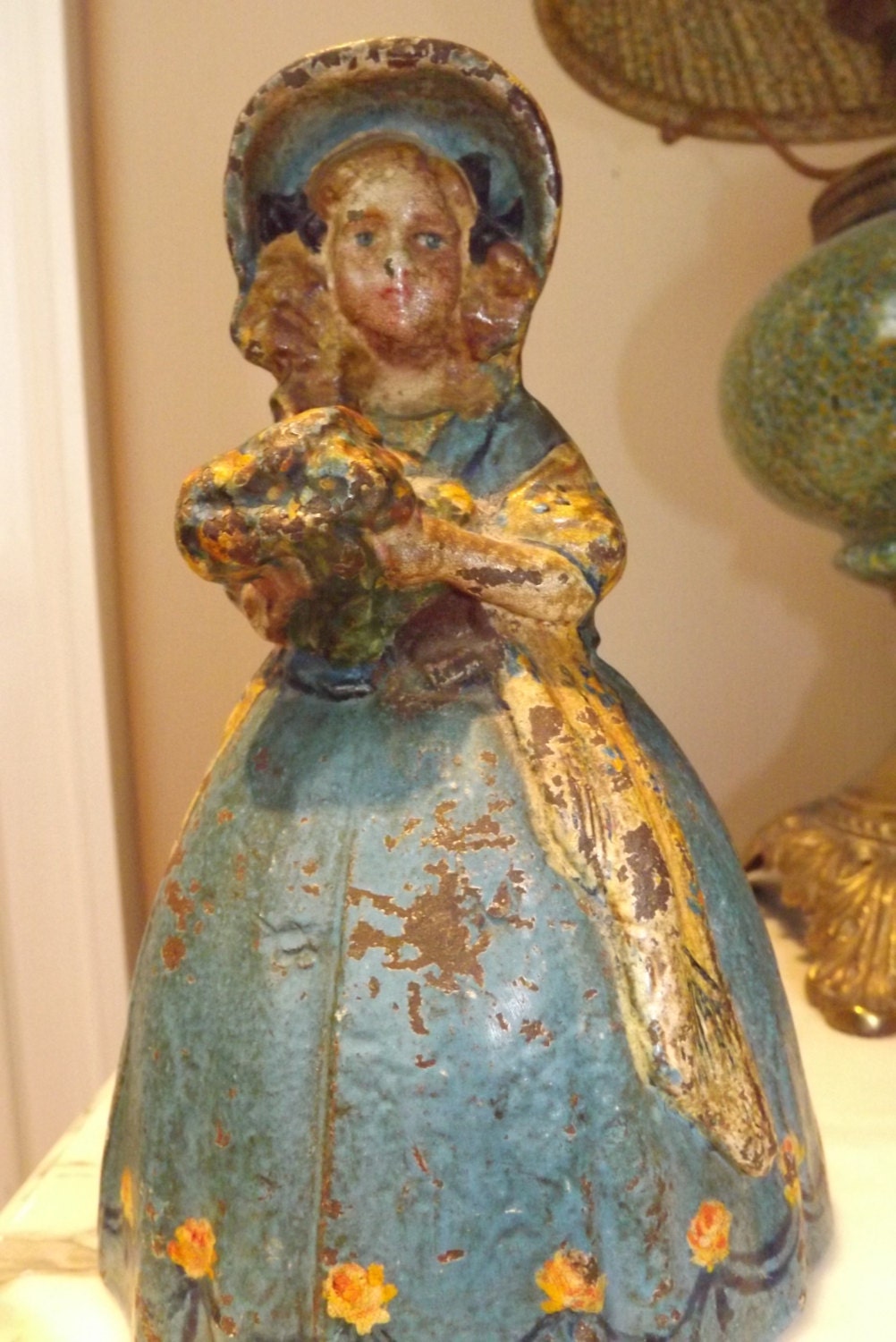 Figural Antique Cast Iron Door Stop Lady with Flowers and