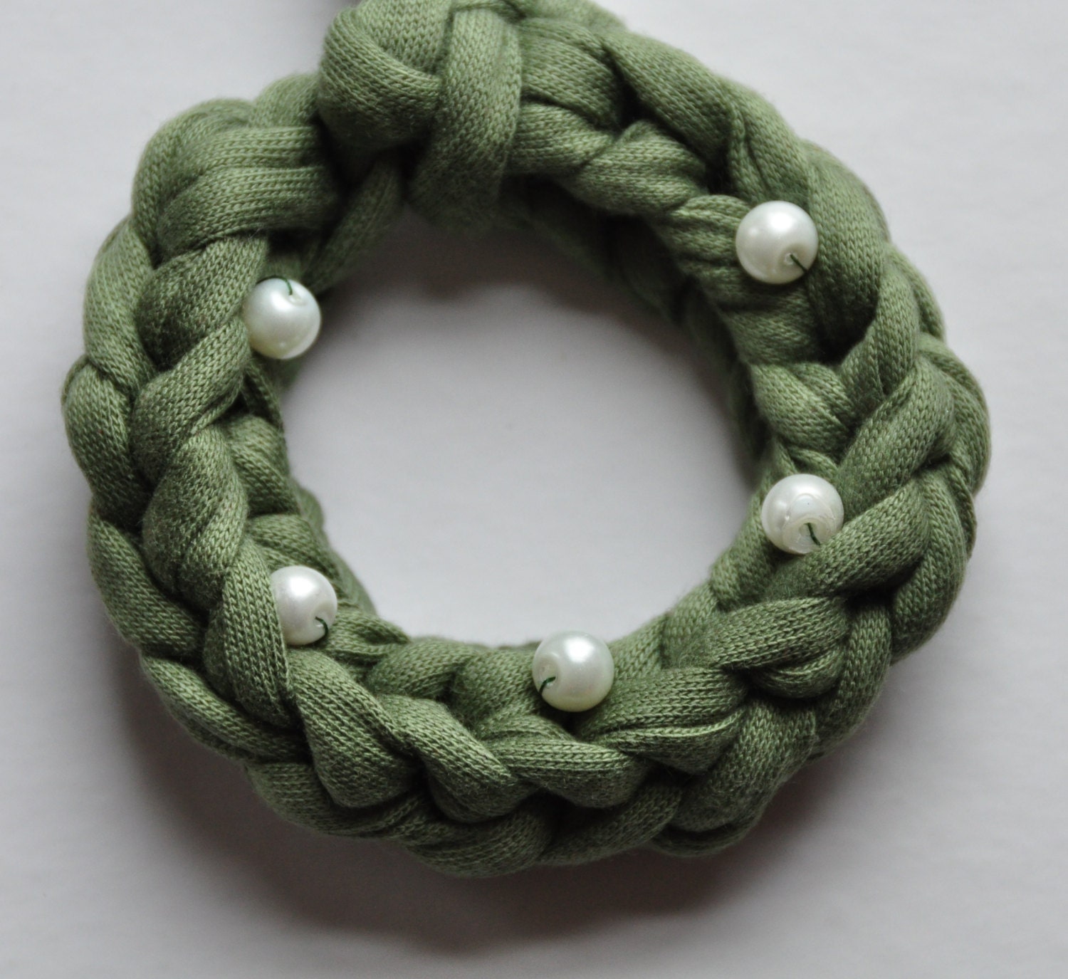 Green mini wreath with glass beads for in the Christmas tree.