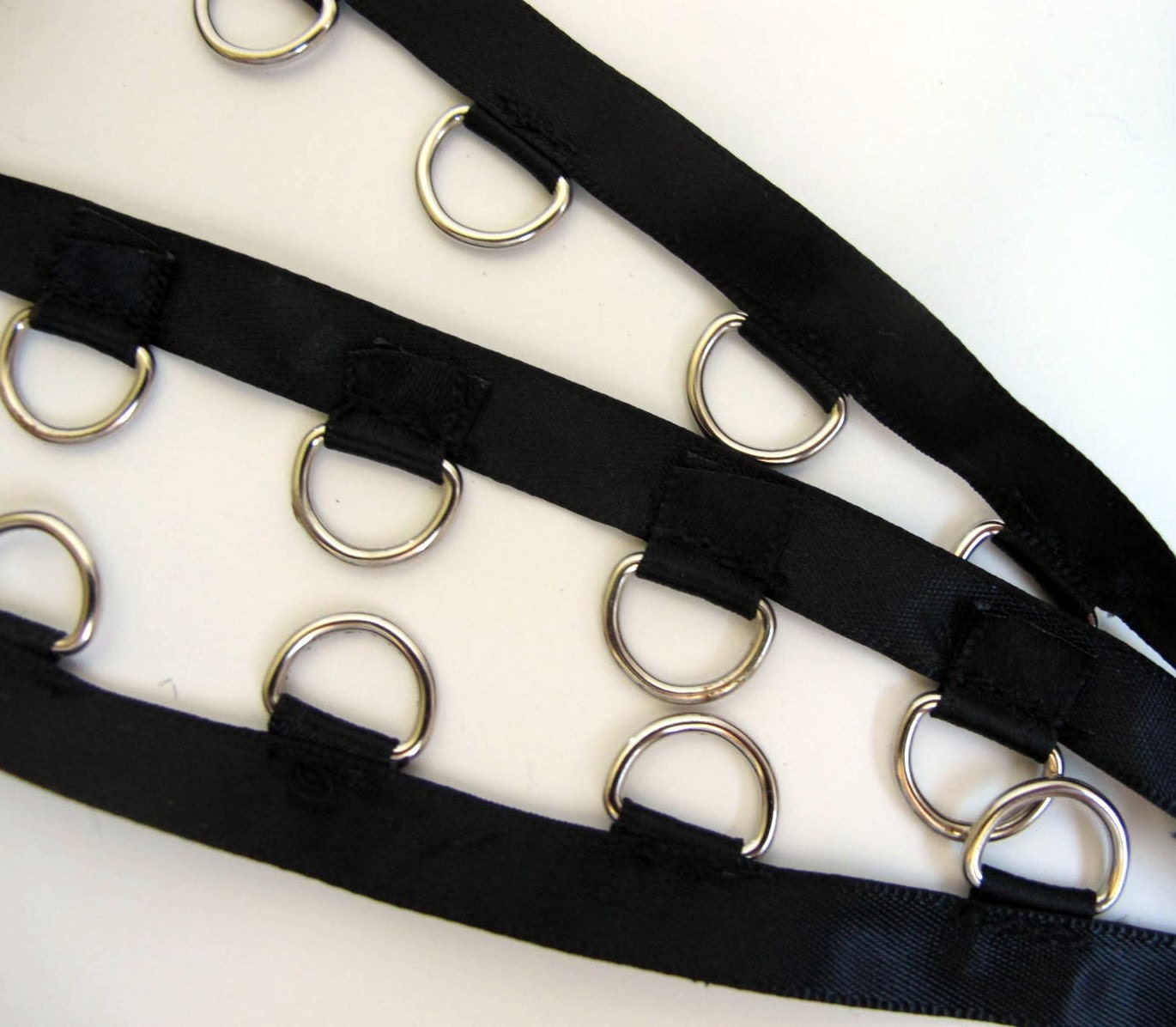 1 y 18 D RINGS on black satin TAPE with nickel D rings.