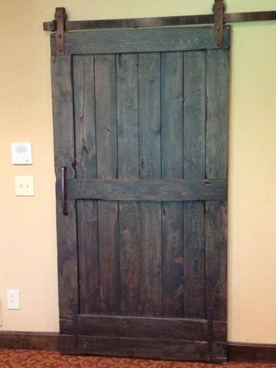 Antique french doors and transom used to create a sliding barn door