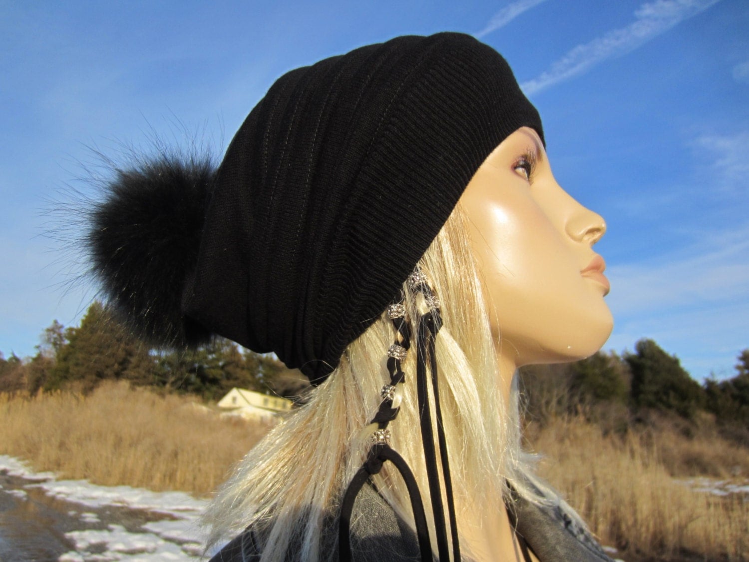 black wooly hat with fur pom pom