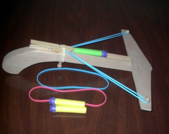 Wooden crossbow that shoots nerf darts.