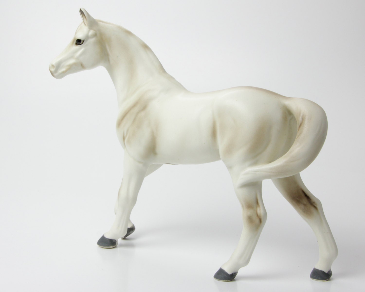 white ceramic horse statue