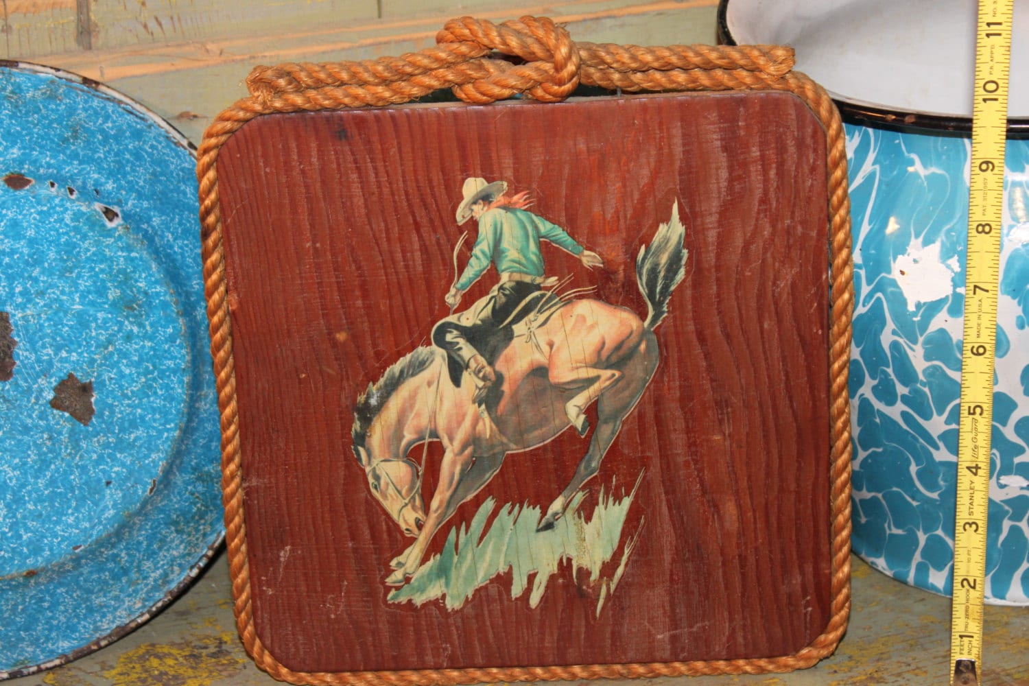 old wood board with cowboy stencil and rope trim