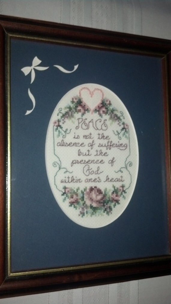 This counted cross stitch wall hanging with oval matt framed