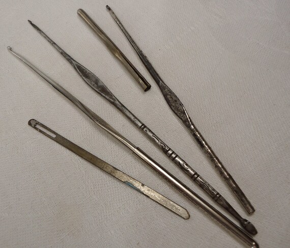 Three vintage metal crochet hooks and a by vintagebuttonemporiu