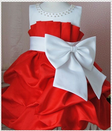 white gown with red ribbon