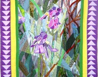 Iris Medley - A Fractured Landscape Quilt, measuring 43" X 56" depicts two irises in pink, purple and yellow shades amidst a woodland scene