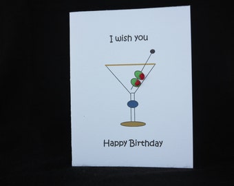 Birthday card with martini glass and two olives with red knots. The inside reads, "with olive my heart."
