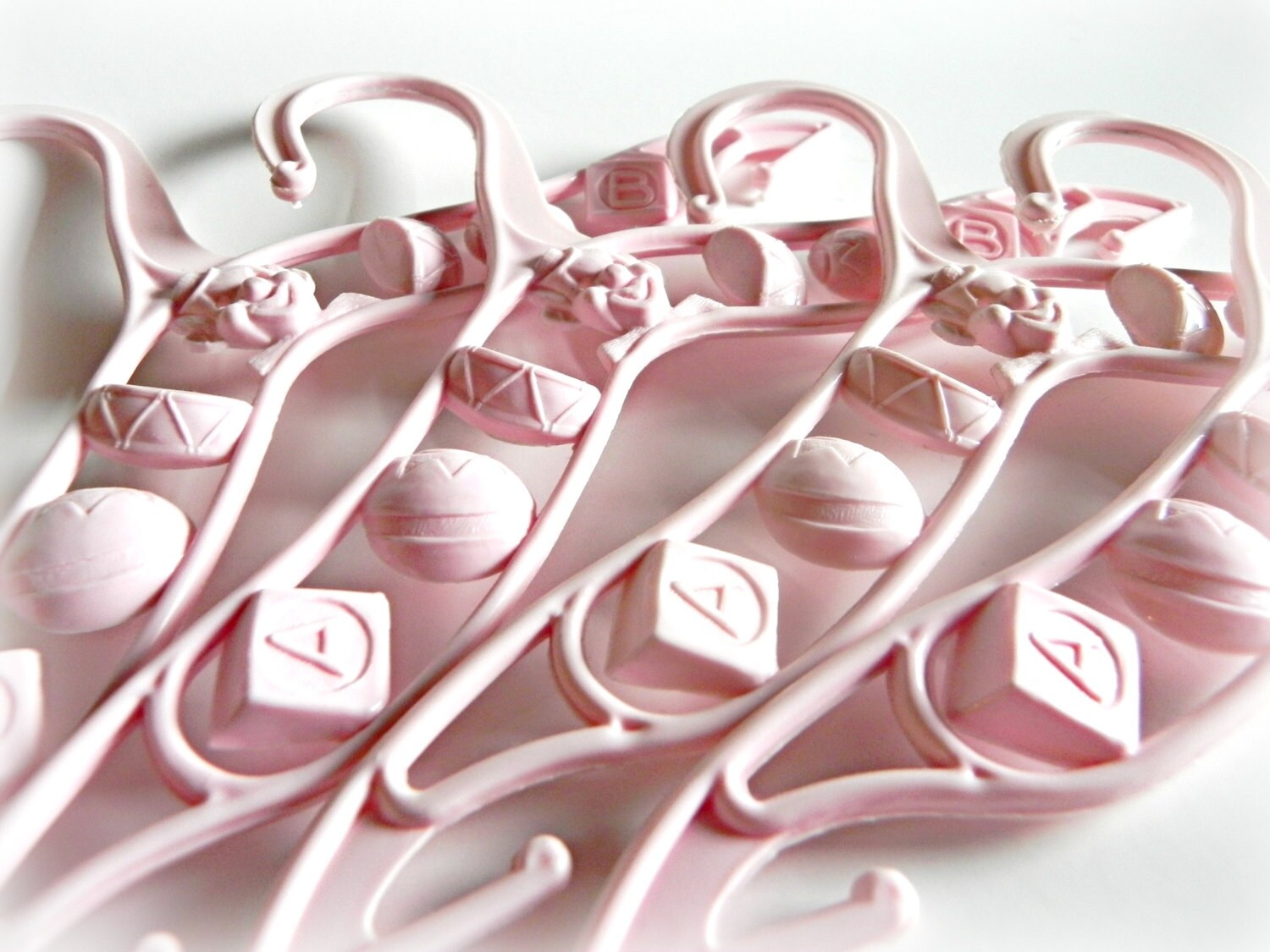 Pink vintage baby clothes hangers