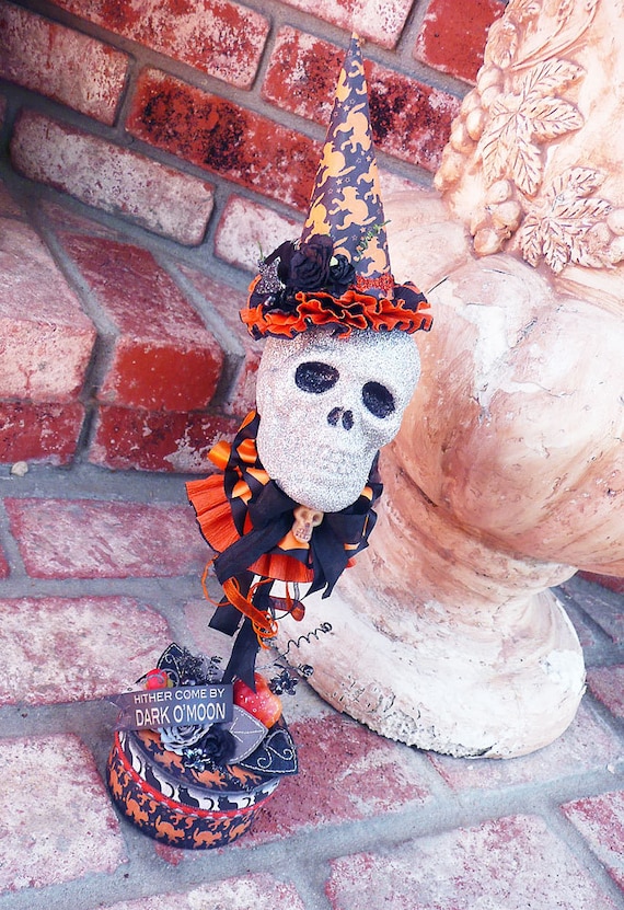 ooak spooky handmade Halloween glitter covered skull wearing a pointy hat on a stick with a built in stand