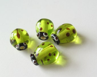 Glass ladybug beads light green 4 pcs.