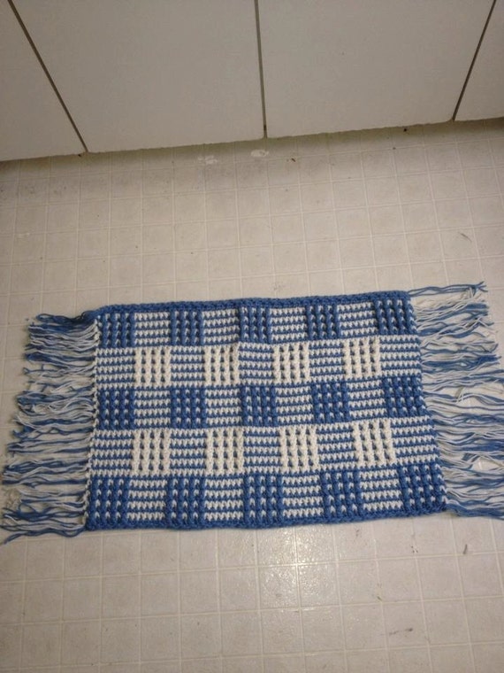 blue and white checkered handmade rug with fringe