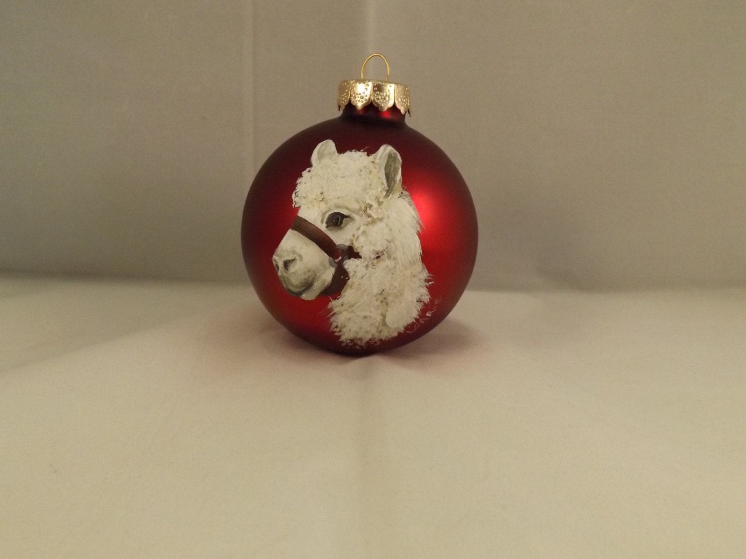 alpaca painted on red glass christmas ornament alpaca painted on red glass christmas ornament