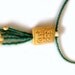 Green Beaded Necklace With Rectangular Carved Bone Flower Bead With Beaded Fringe