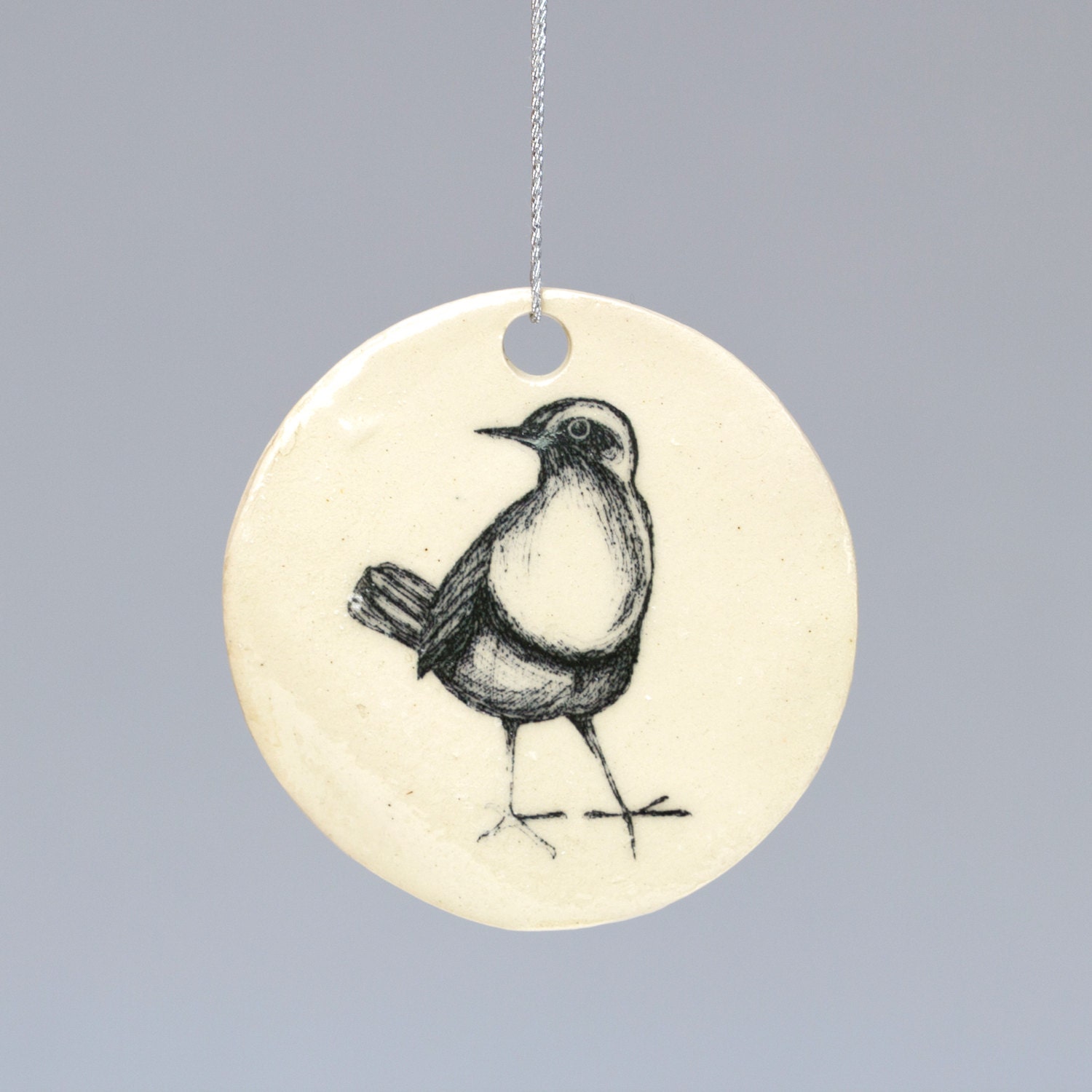 Ceramic handmade Robin Christmas Decoration hanger. Hand illustrated design. White, cream illustration