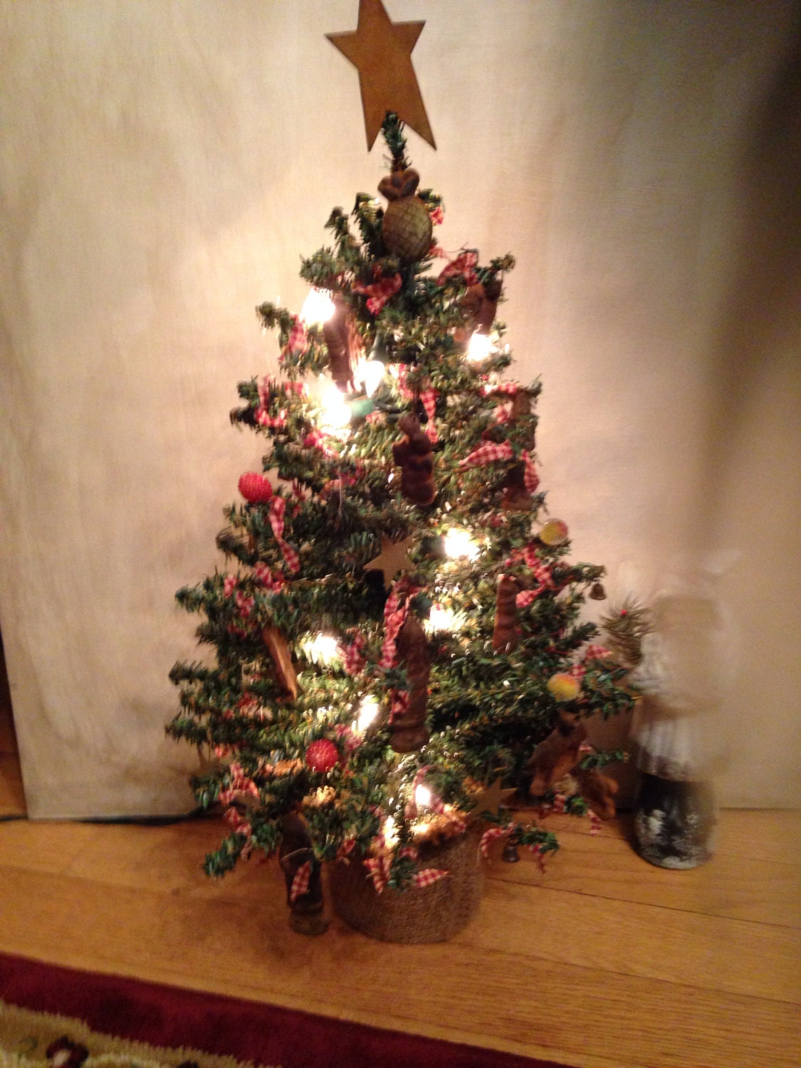 Holiday table top pre-lit tree with handmade papier mache' ornaments.