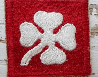 Red Patch With White Four Leaf Clover