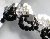 square knot fan micro macrame bracelet on black nylon cord.