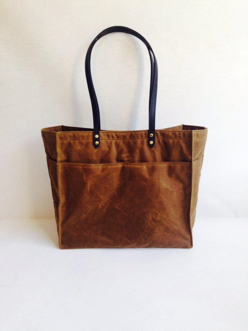 Waxed canvas tote with leather handles and inside pocket