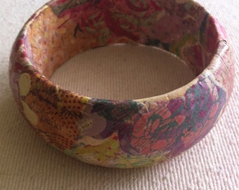 Wood bangle with springy floral paper mache design, 2.75" wrist, 3.25" outer diameter.