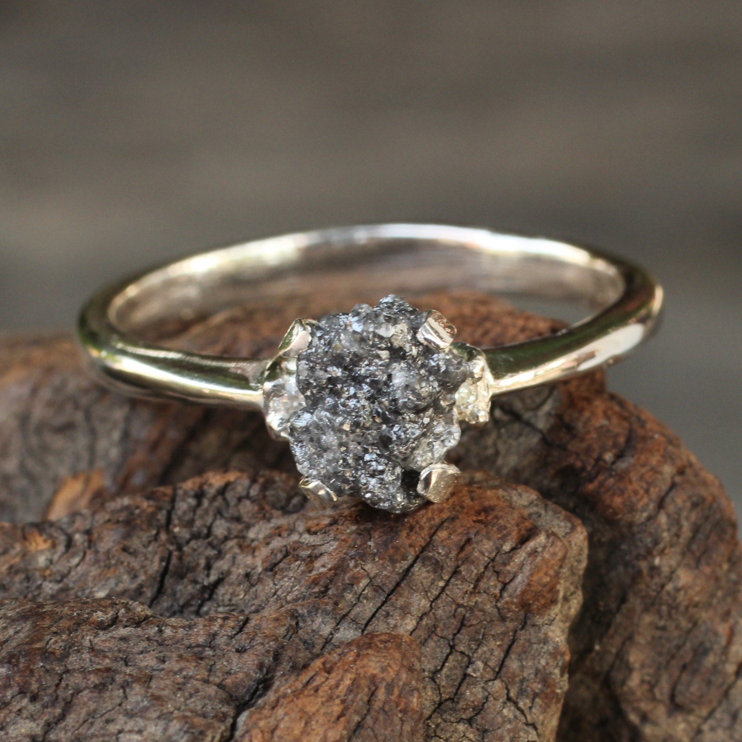 Rough diamond ring with traditional cut side set diamond in