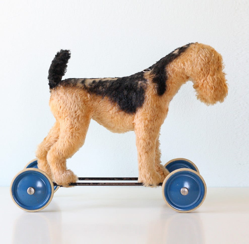 toy dog on wheels with lead
