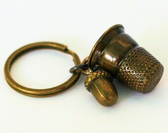 Peter Pan Thimble and Acorn Hidden Kisses Key Ring Brass Peter Pan and Wendy