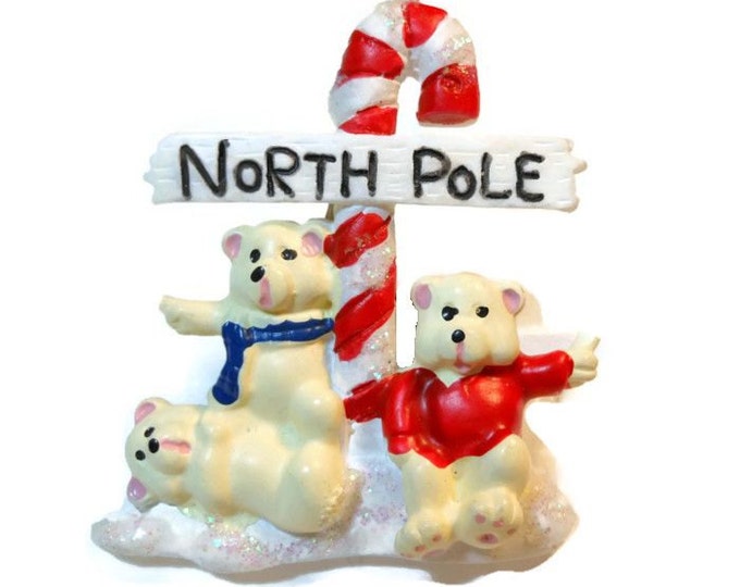 Christmas brooch - which way to the North Pole now? Three bears hitchhiking their way to the North Pole in front of a candy cane road sign