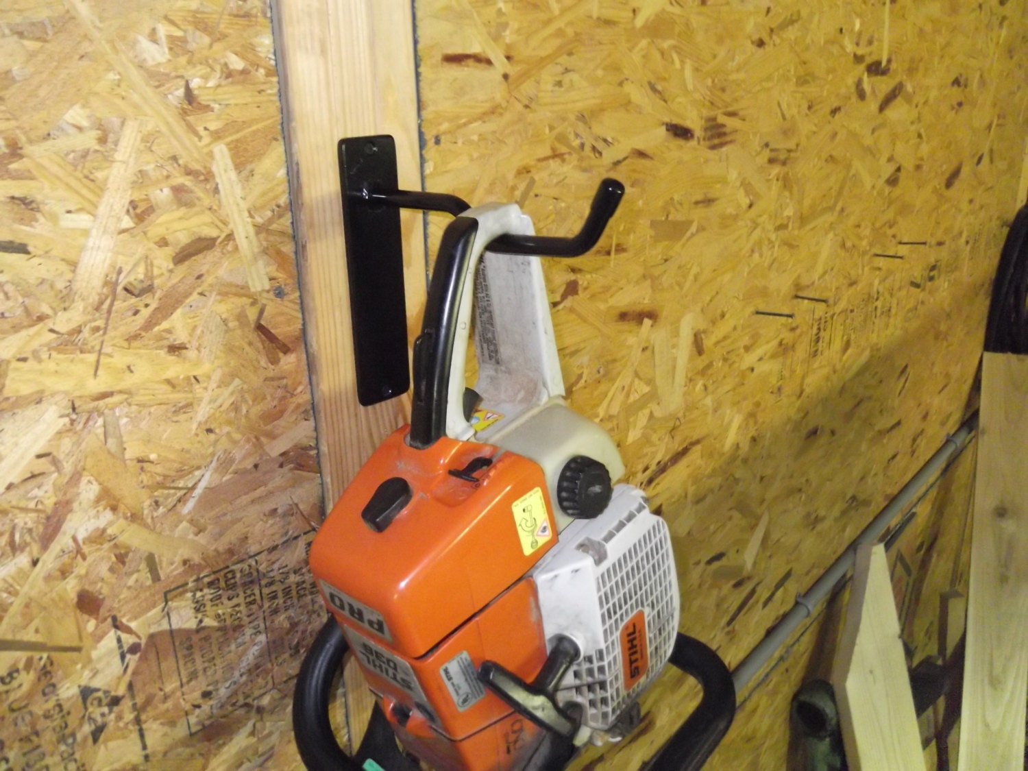 Chain saw wall hanger storage display