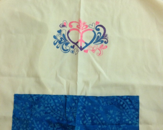Full Adult Canvas Apron that ties in the back. Two blue patterned pockets in front, Heart/flower/peace sign design painted on front.