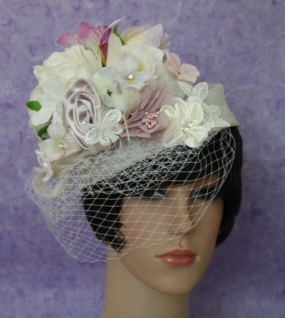 An Off White Wedding Or Church Pillbox Hat Decorated With