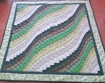 Handcrafted green patchwork bargello lap quilt.